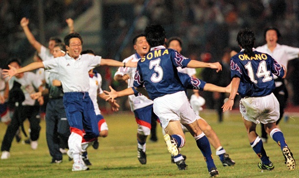 W杯フランス大会アジア第3代表決定戦で決勝ゴールを決めた岡野(14)を迎える岡田監督(左端)=1997年11月16日、マレーシア・ジョホールバル